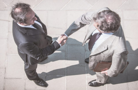 500px Photo ID: 150465677 - Minimalist concept with businessmen handshake